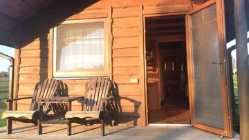 Фото номера Двухместный номер с 1 кроватью и патио Кемпинги Iecupes wooden cabin with view to river г. Иецава 6